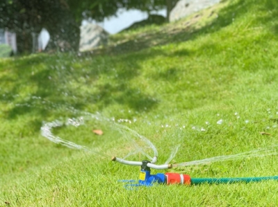 Three-arm brass rotating sprinkler on butterfly base